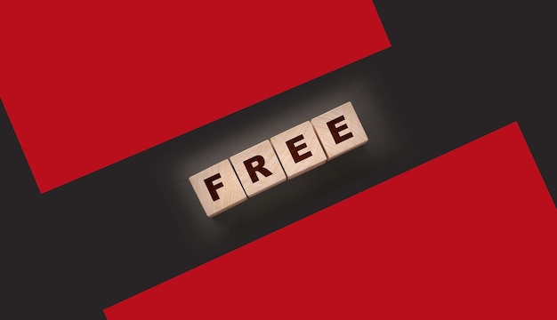 The word free on wooden blocks on black background Business concept