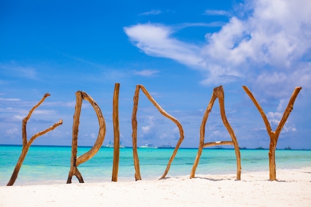 Word friday made of wood on boracay island background turquoise sea