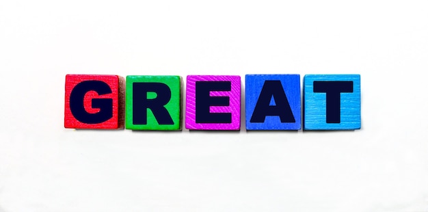 The word GREAT is written on colorful cubes on a light background