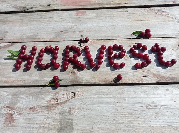 word, harvest ,laid out,on an old, wooden, table, berries, ripe, juicy, red, cherry, background