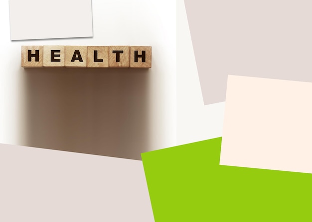 word health on wooden cubes and color papers around healthcare concept