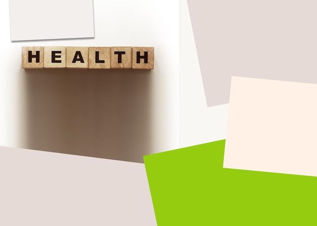 Word health on wooden cubes and color papers around healthcare concept