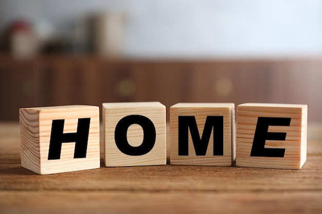 Word HOME on wooden background