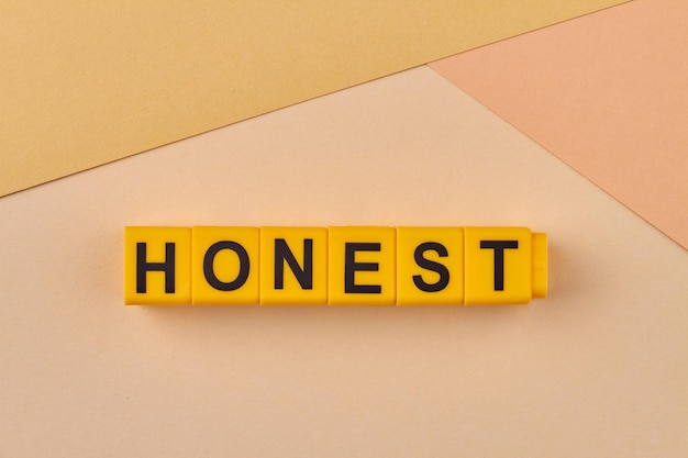 The word honest written on yellow cubes close up free of deceit truthful and sincere