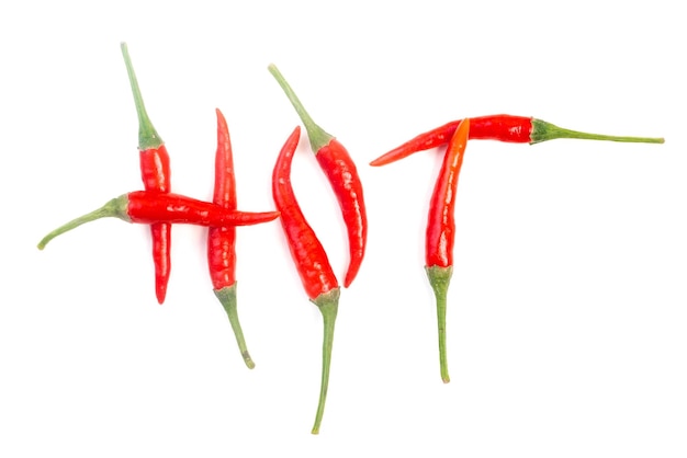 The word hot built of red chili peppers with green stems on a white background Isolated