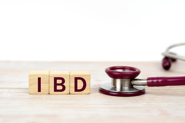 word IBD ( Inflammatory bowel disease ) on wooden blocks and stethoscope on white background. Medica