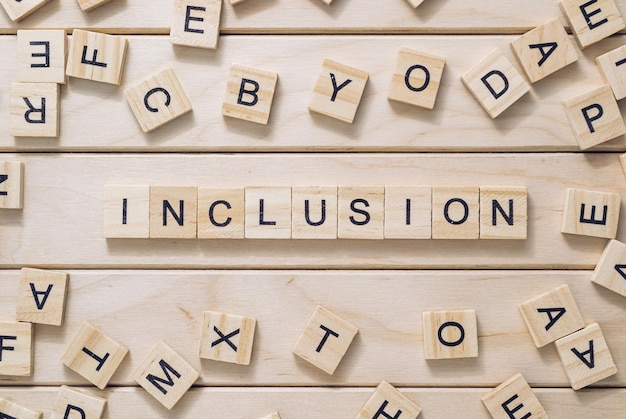 word inclusion made with letter blocks on wooden boards