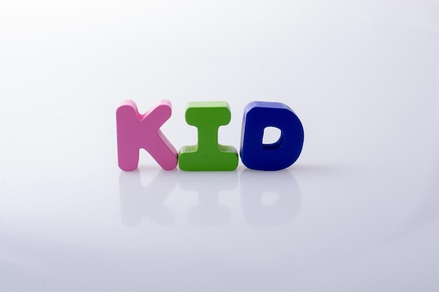 Photo the word kid written with colorful letter blocks on white