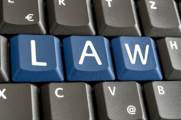 Word LAW written with blue keys on computer keyboard