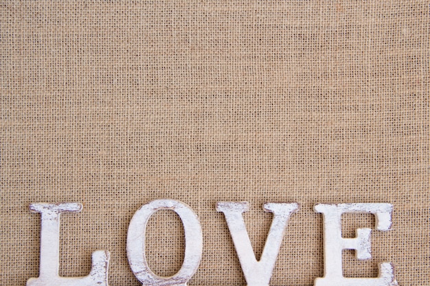 Word love on burlap top view with copy space