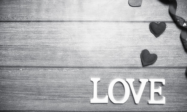 The word love made up of white wooden letters on a wooden background