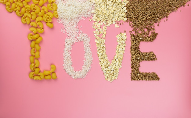 Word love on a pink wall from cereals