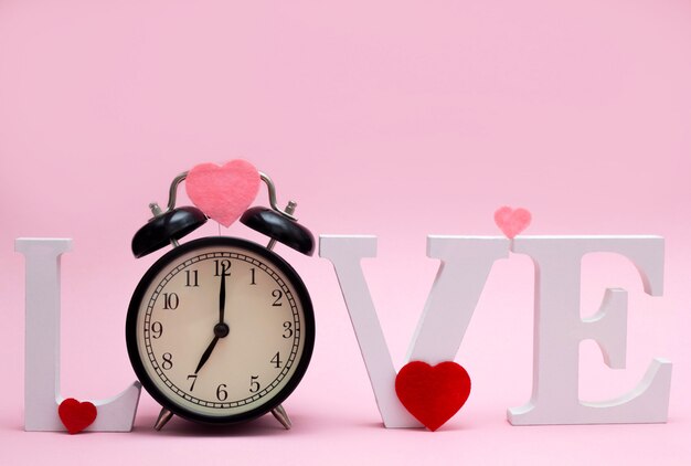 Word love with a clock instead of the letter o