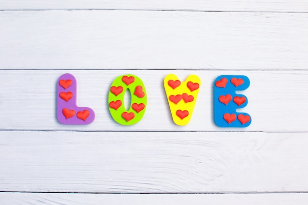 Word Love on wooden background closeup