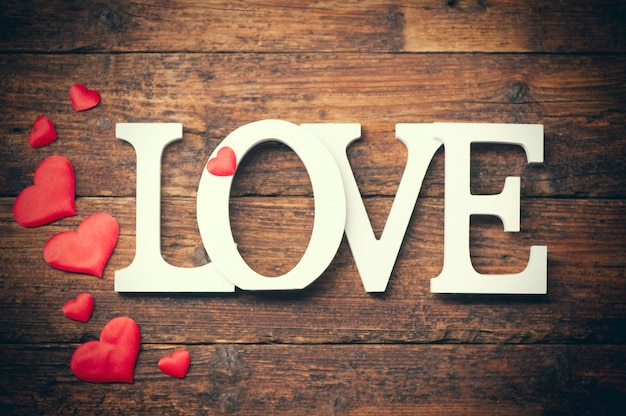 Word LOVE written on wooden background