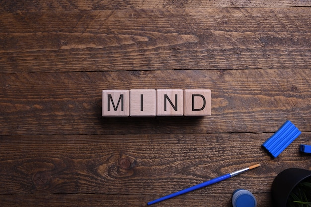 Word mind wooden cubes, blocks on the subject of education, development and training on a wooden table. Top view. .