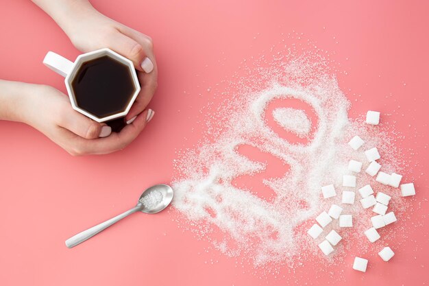 Photo word no made of sugar and cup of coffee on pink background flat lay