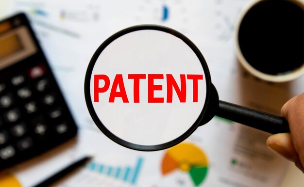 Photo the word patent in a magnifying glass