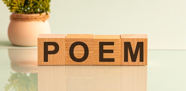 Word poem made with block wooden letters next to a flowers composition