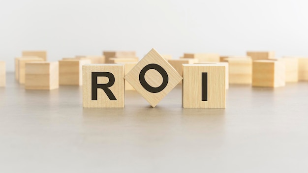 Word ROI is made of wooden blocks on white background