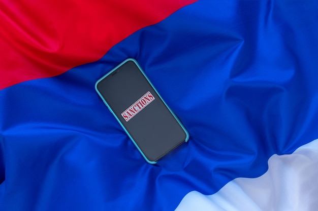 The word Sanctions on the Serbian flag Aggravation of the Serbian and Kosovo conflict concept