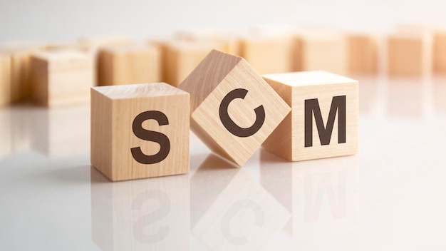 Word SCM made with wood building blocks stock image background may have blur effect