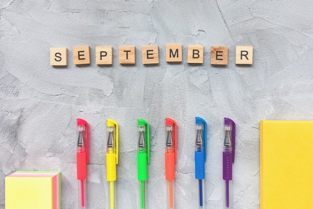 Word SEPTEMBER and multicolored gel pens