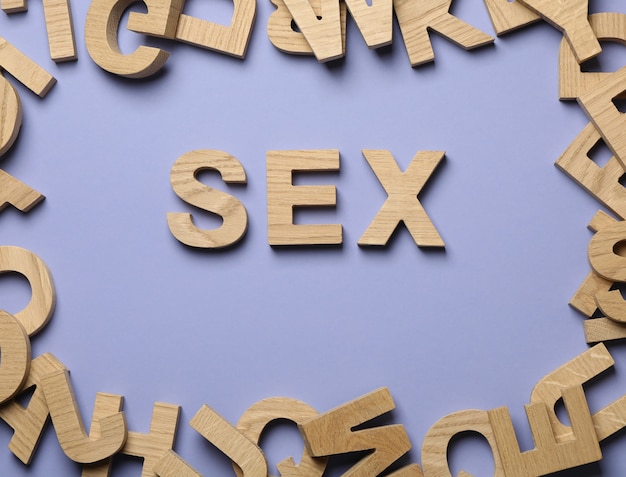 Word Sex and wooden letters on violet wall