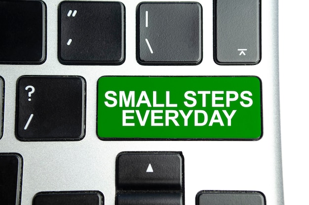 Word small steps everyday on green keyboard button Business concept