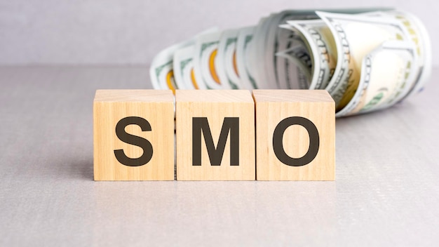 Word SMO on wooden cubes grey background