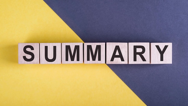 Word SUMMARY on wooden cubes on yellow gray background