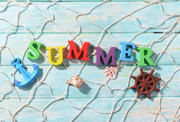 Word summer on wooden background