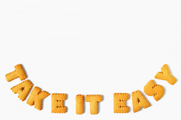 The word TAKE IT EASY made with alphabet shaped biscuits