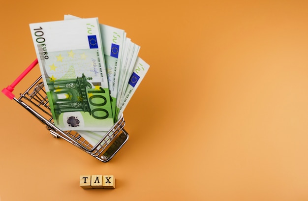 The word tax and the currency of the European Union on toy cart