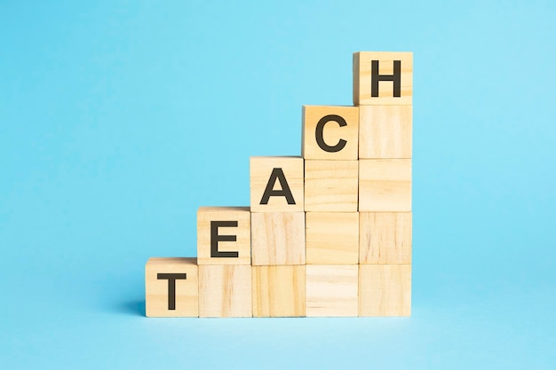 The word TEACH is written on a wooden cubes concept