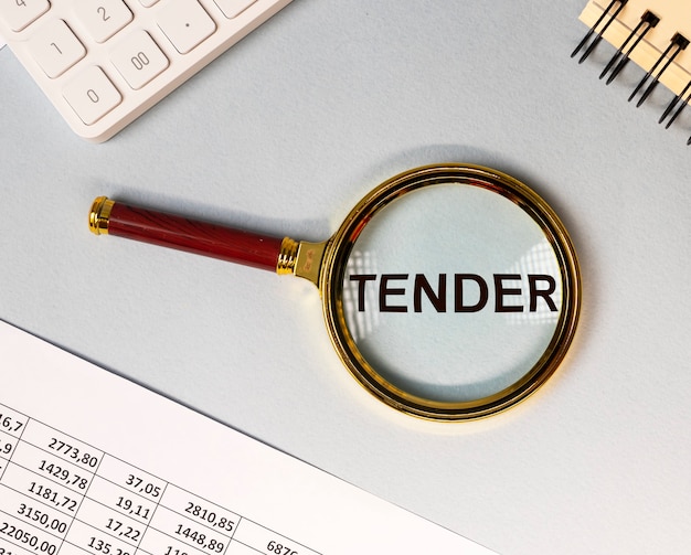 Word tender through magnifying lens on office desk