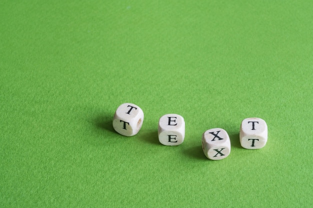 The word Text made of small wooden scrabble letters