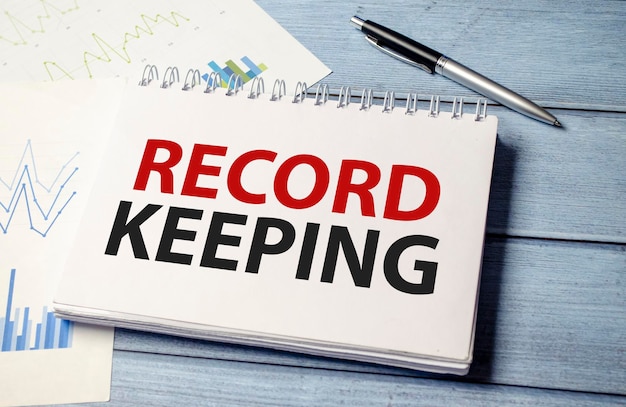 Word text RECORD KEEPING on white paper card business concept