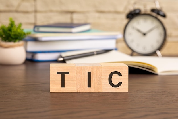 the word TIC formed from wooden blocks suggests a concept related to technology innovation and connectivity It may symbolize trends like innovation connectivity and information technology