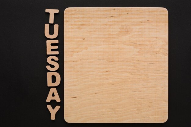 Word Tuesday with blank wooden board. Timetable, day of week, to-do-list, time management concept