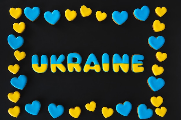 The word Ukraine on a black background made with handmade gingerbread