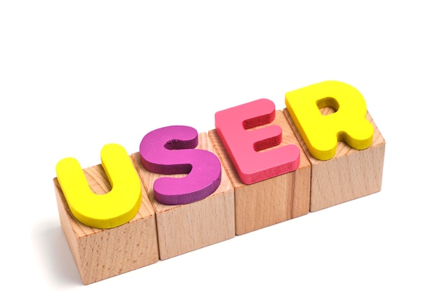 Word user is laid out on wooden cubes and on a white background