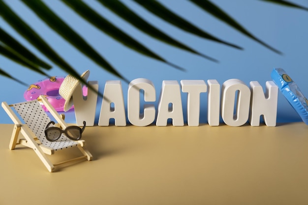 Word vacation made from white concrete letters on the blue background