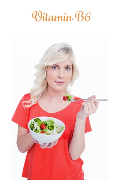 The word vitamin b6 against young blonde woman eating a vegetable salad