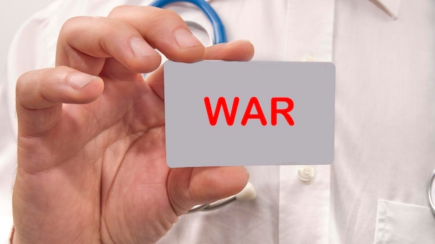 A word WAR on the card in the man's hand War Concept