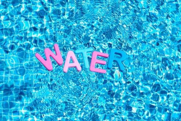 word water in colors floating over a pool copy space
