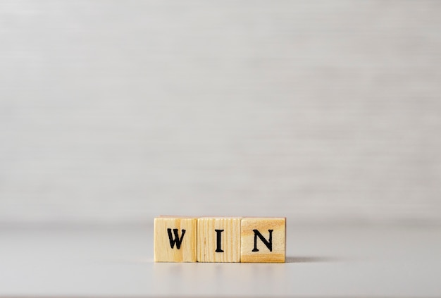 The word win made of letters on wooden cubes