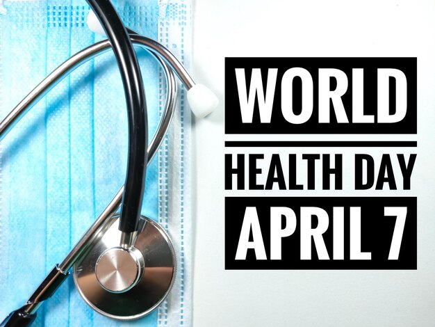 Photo word world health day april 7 on white background with face mask and stethoscope