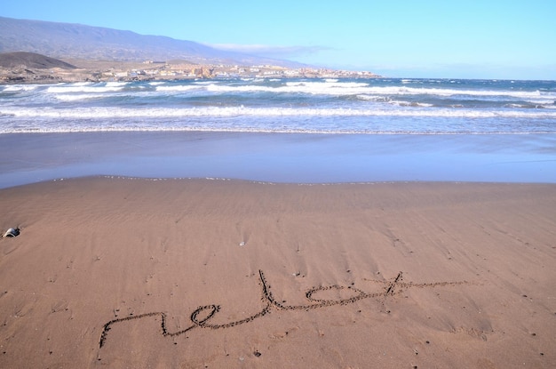 Photo word written on the sand