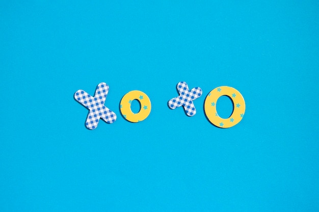 The word xoxo from multicolored letters of the alphabet on a blue background top view flat lay